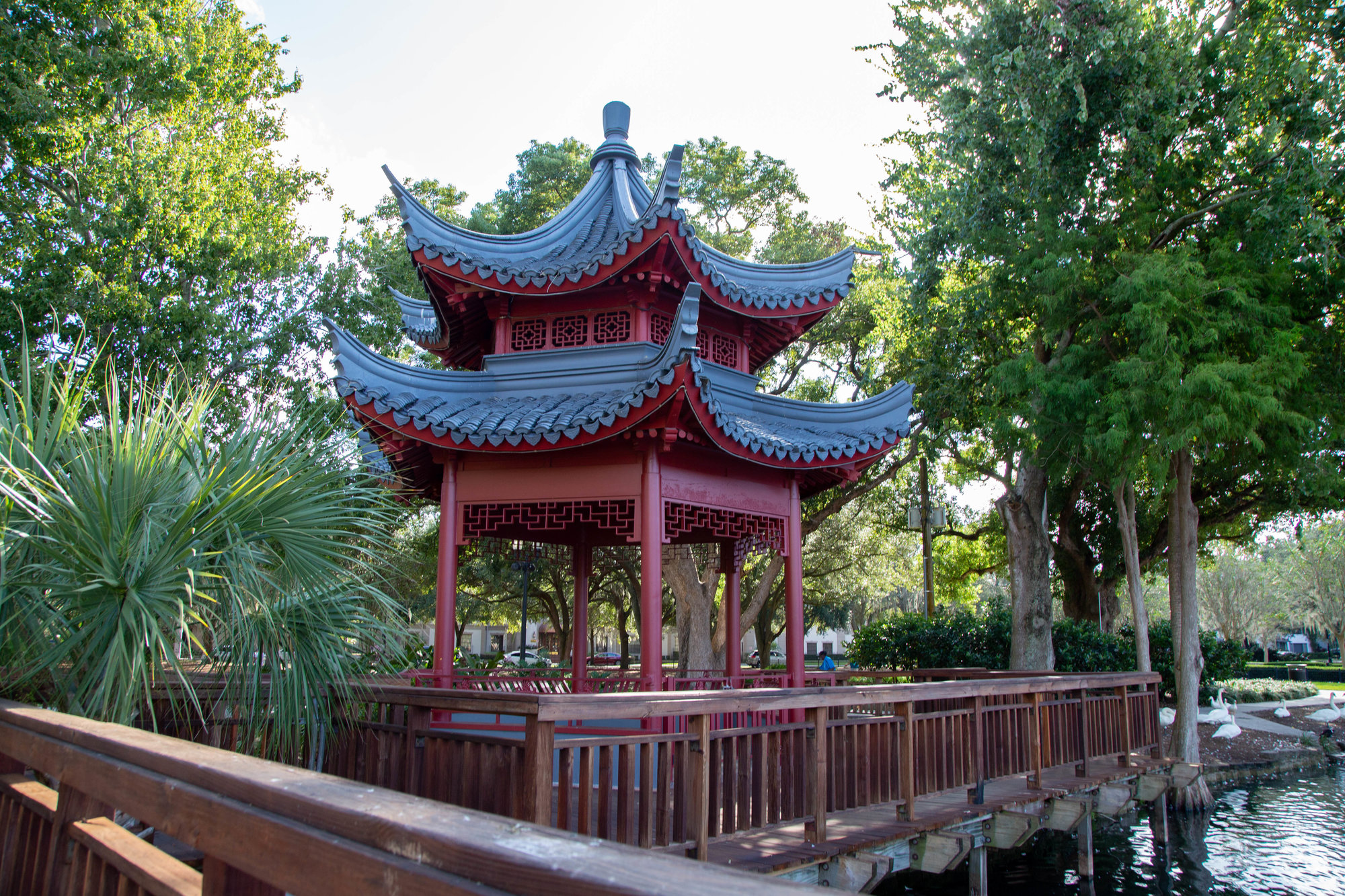 chinese ting red building with trees around it